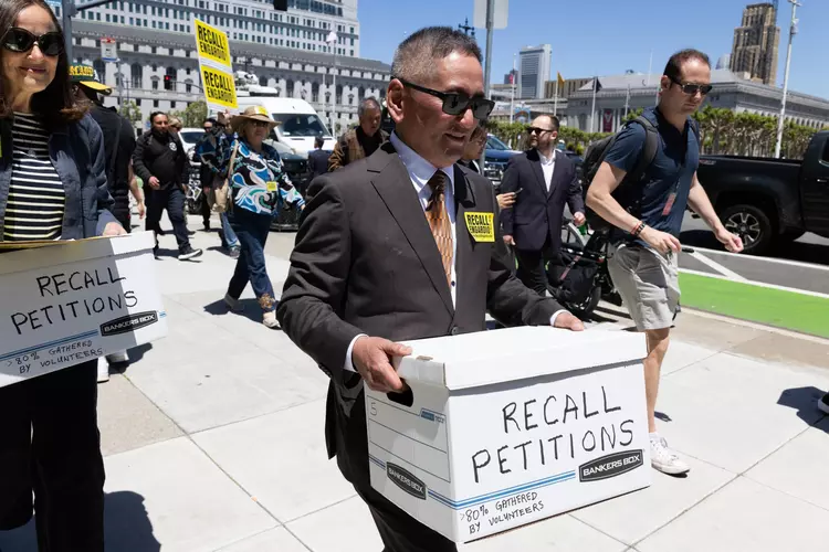 Albert Chow carries petitions to recall Supervisor Joel Engardio to the Department of Elections.