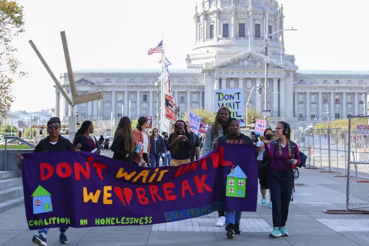 Unhoused families and supporters of the Coalition on Homelessness march outside of San Francisco City Hall on Oct. 11, 2022.