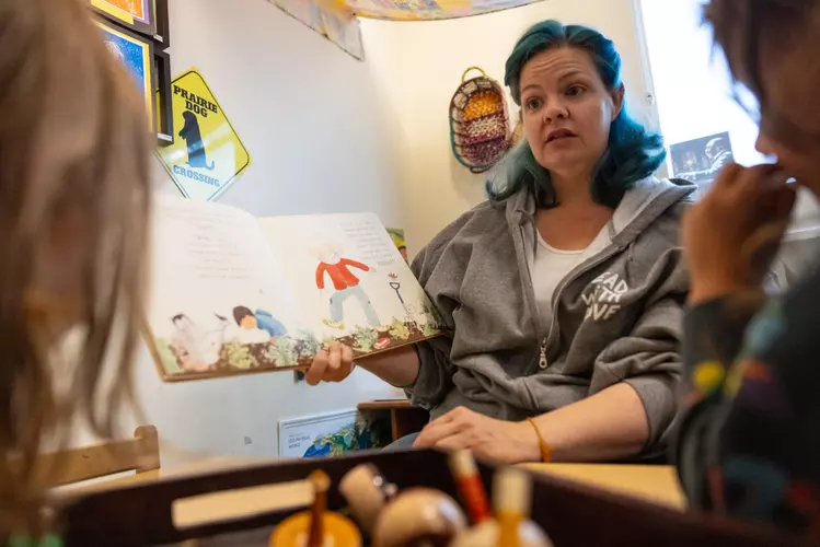 Tracy Tsiropoulos reads to children at Pacific Primary in San Francisco on Monday. Prop. C came with the future promise of universal child care, but now it faces cuts under the mayor’s budget. | Isaac Ceja/The Standard